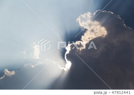 the sun shines out of the clouds. 47912441