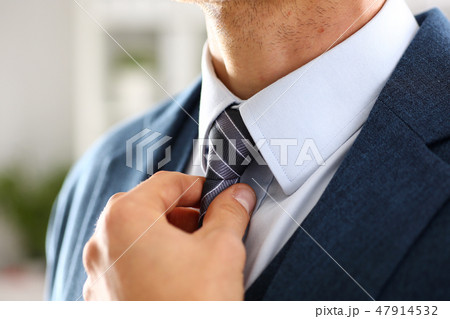 Male arm in blue suit set tie closeup 47914532