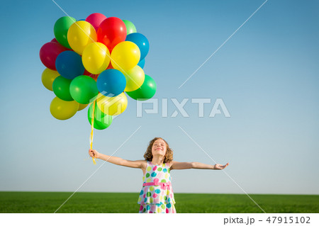 Happy child playing outdoors in spring field 47915102