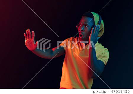 The young handsome hipster man listening music with headphones 47915439