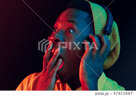 The young handsome hipster man listening music with headphones The young handsome hipster man listening music with headphones 47915697