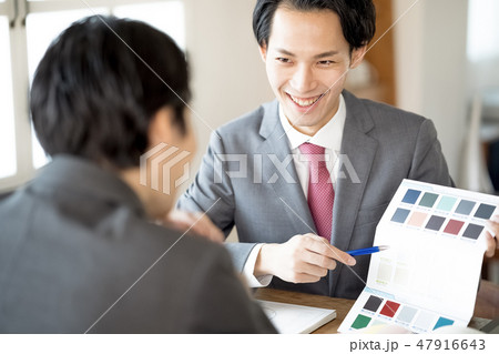 お客様へ色見本を提示し笑顔で内装の提案をする設計事務所の一級建築士男性ビジネスマン お客様へ色見本を提示し笑顔で内装の提案をする設計事務所の一級建築士男性ビジネスマン 47916643