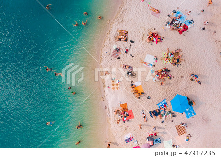 aerial view of sunny sandy beach with blue azure water 47917235