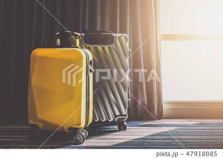 Suitcase Luggage bag in the bedroom with open curtain see sunrise light 47918085