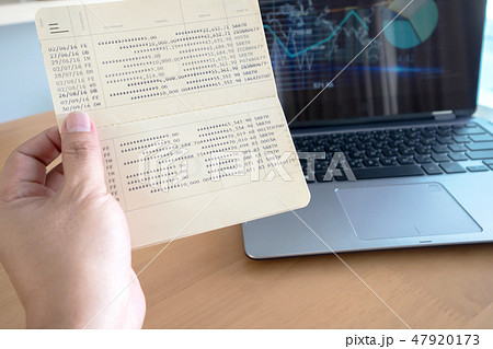 Woman hold passbook on hand,laptop background 47920173