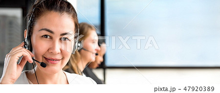 Asian woman working in call center with team Asian woman working in call center with team 47920389