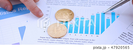 Golden btc sign coin lying at stats graph closeup 47920565