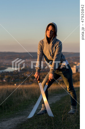 Girl on a high mountain trains with a machete Girl on a high mountain trains with a machete 47920842