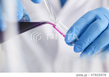 A male chemist holds test tube of glass 47920976
