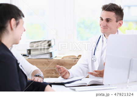 Male family doctor listen carefully young 47921324
