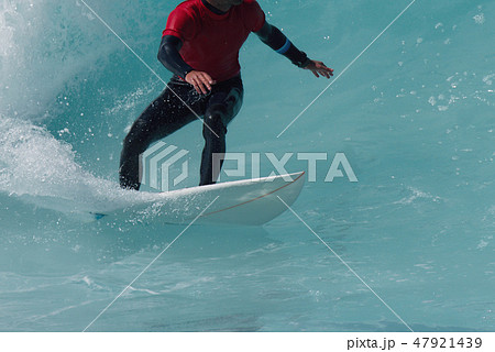 Sports man surfing wave on surfboard in ocean 47921439