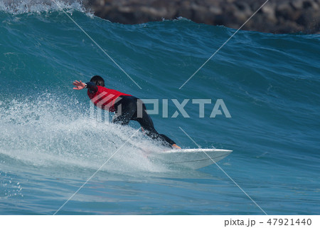 Sports man surfing wave on surfboard in ocean 47921440