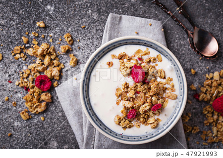 Granola with yogurt and dried raspberries Granola with yogurt and dried raspberries 47921993