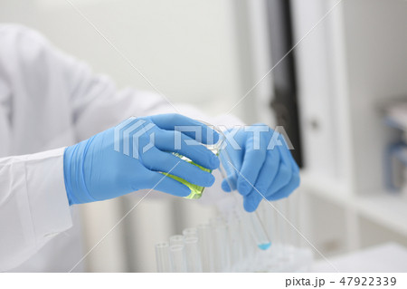 A male chemist holds test tube of glass 47922339