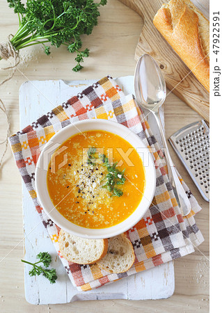 Carrot cream soup with parsley, cheese, baguette Carrot cream soup with parsley, cheese, baguette 47922591