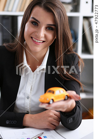 Business woman in the office holds a miniature Business woman in the office holds a miniature 47922773