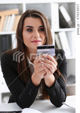 Business woman in the office holds plastic credit Business woman in the office holds plastic credit 47923057