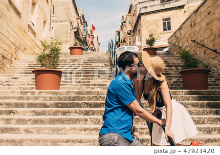 Man and woman walking and kissing on the stairs Man and woman walking and kissing on the stairs 47923420