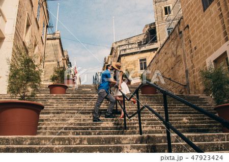 Man and woman walking and kissing on the stairs Man and woman walking and kissing on the stairs 47923424