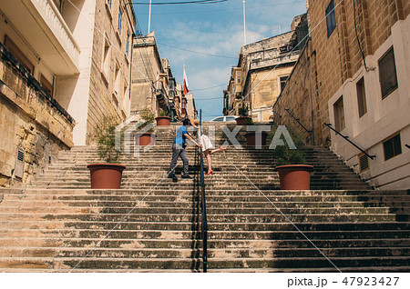 Man and woman walking and kissing on the stairs  47923427