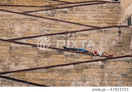Man and woman laying on the city walls Man and woman laying on the city walls 47923725