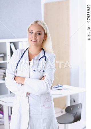 Beautiful smiling female doctor stand in office portrait 47923980