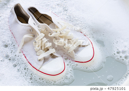 Soak shoes before washing. Dirty sneakers. 47925101