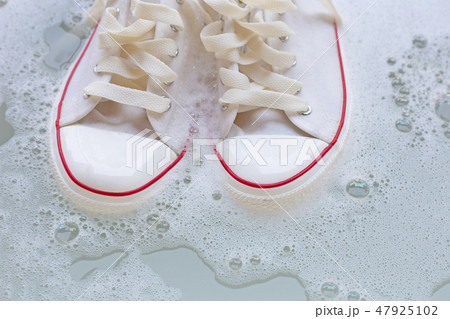 Soak shoes before washing. Dirty sneakers. 47925102