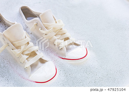 Soak shoes before washing. Dirty sneakers. Soak shoes before washing. Dirty sneakers. 47925104