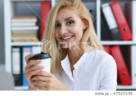 Smiling business woman drinking coffee from 47925546