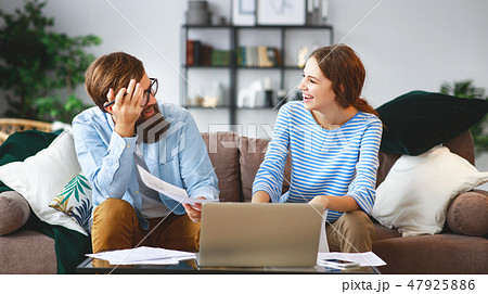 married couple with bills receipts documents  47925886