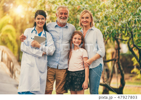Happy healthy family and doctor talking in park. 47927803