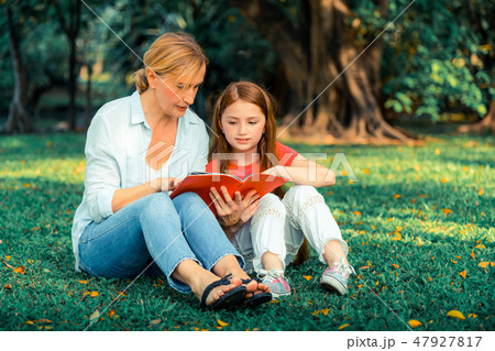 Happy mother and little kid daughter in park. Happy mother and little kid daughter in park. 47927817