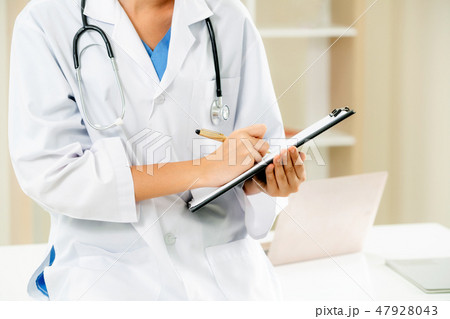 Young female doctor working in hospital office. Young female doctor working in hospital office. 47928043