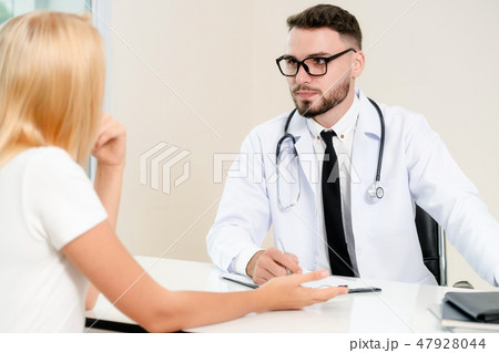 Male Doctor and Female Patient in Hospital Office Male Doctor and Female Patient in Hospital Office 47928044