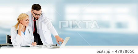 Doctors working with laptop computer in hospital. Doctors working with laptop computer in hospital. 47928050