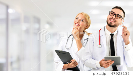 Doctor at hospital works on computer with partner. Doctor at hospital works on computer with partner. 47928153