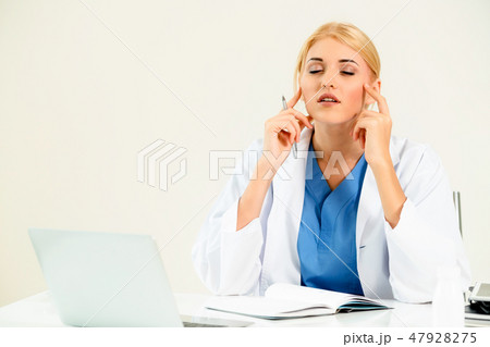 Doctor in hospital working on medical report. 47928275