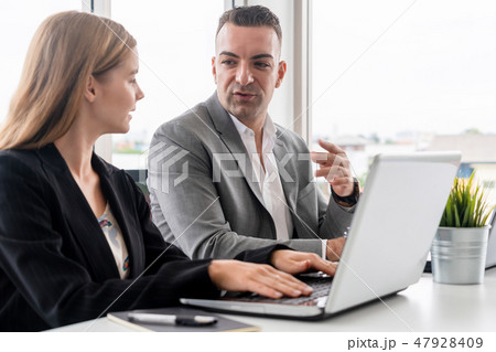 Businessman and businesswoman working in office. Businessman and businesswoman working in office. 47928409