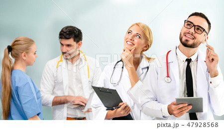 Doctor working in hospital with other doctors. 47928568