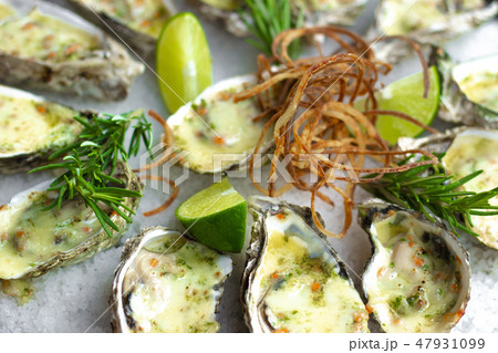 Seafood background. Oysters baked with cheese on plate. Mediterranean cuisine with seafood. Food Seafood background. Oysters baked with cheese on plate. Mediterranean cuisine with seafood. Food 47931099