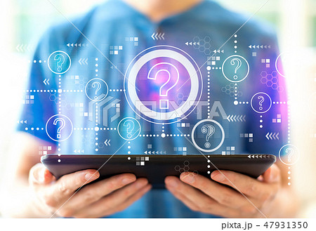 Question marks with man using a tablet Question marks with man using a tablet 47931350