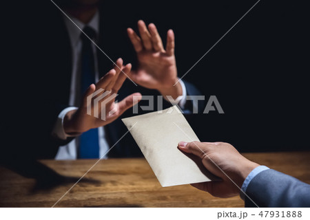 Businessman rejecting bribery money in envelope Businessman rejecting bribery money in envelope 47931888