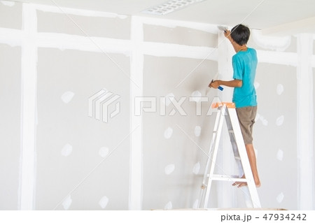 worker male on stair is putting gypsum plaster worker male on stair is putting gypsum plaster 47934242