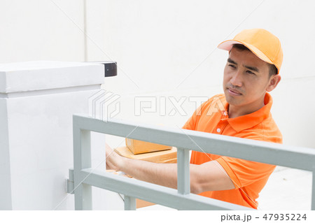 Delivery man ring a bell to call customers  47935224