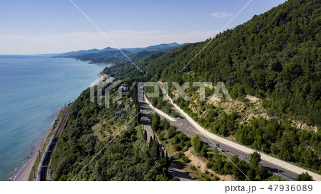 Aerial view of car driving along the winding mountain road in Sochi, Russia. 47936089