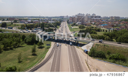 Aerial view of highway and overpass in city on a cloudy day 47936867