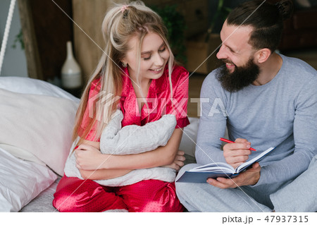 young couple bed anniversary planning make notes young couple bed anniversary planning make notes 47937315