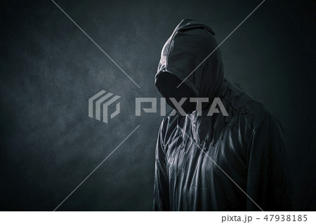 Scary figure in hooded cloak  47938185
