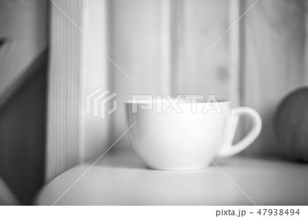 White mug on kitchen table White mug on kitchen table 47938494